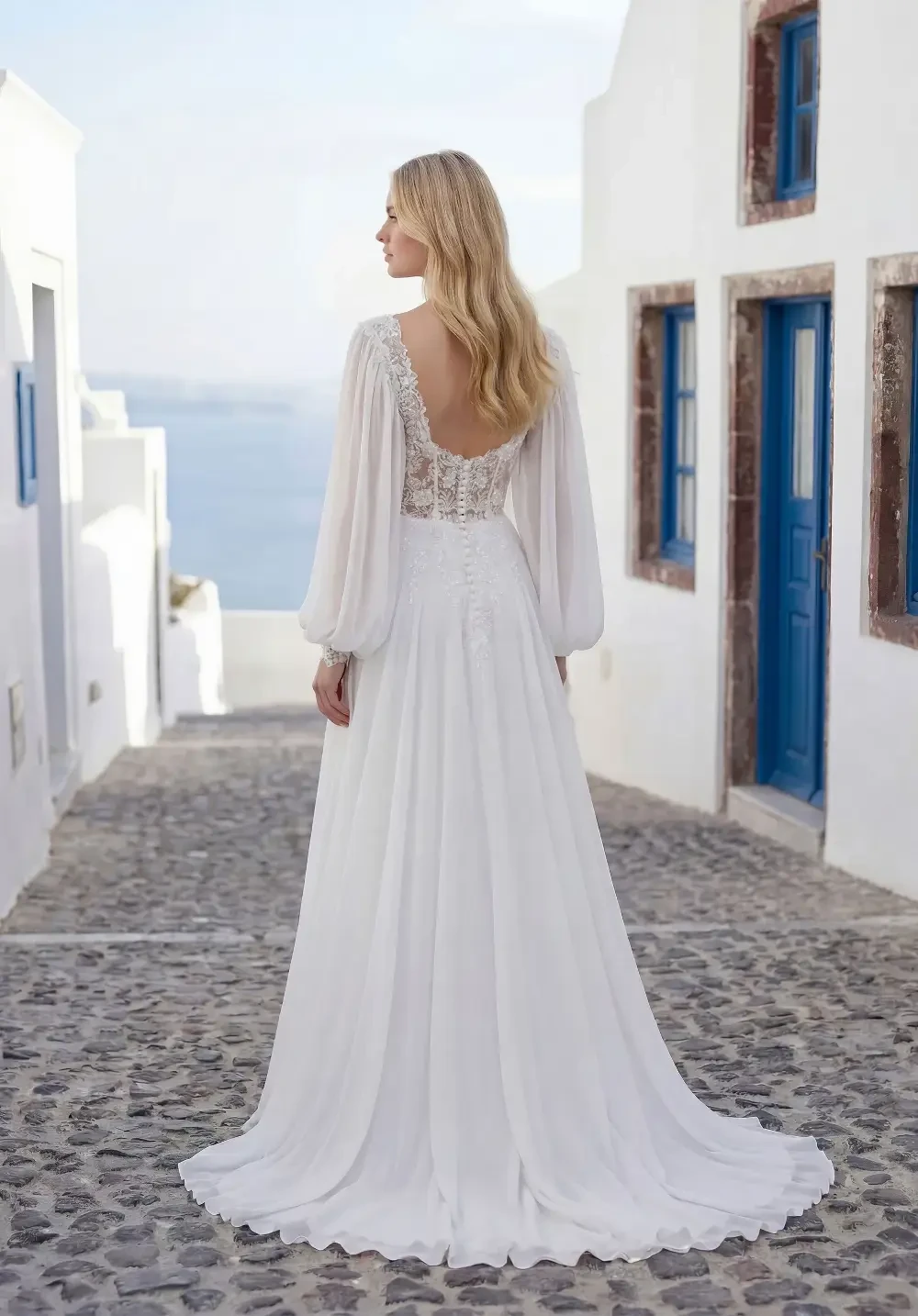 model is wearing a boho long sleeve a-line bridal gown