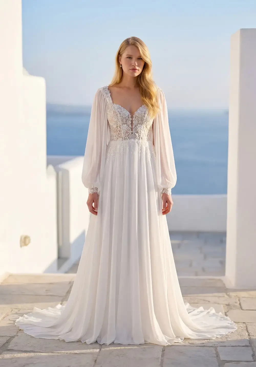model is wearing a boho long sleeve a-line bridal gown
