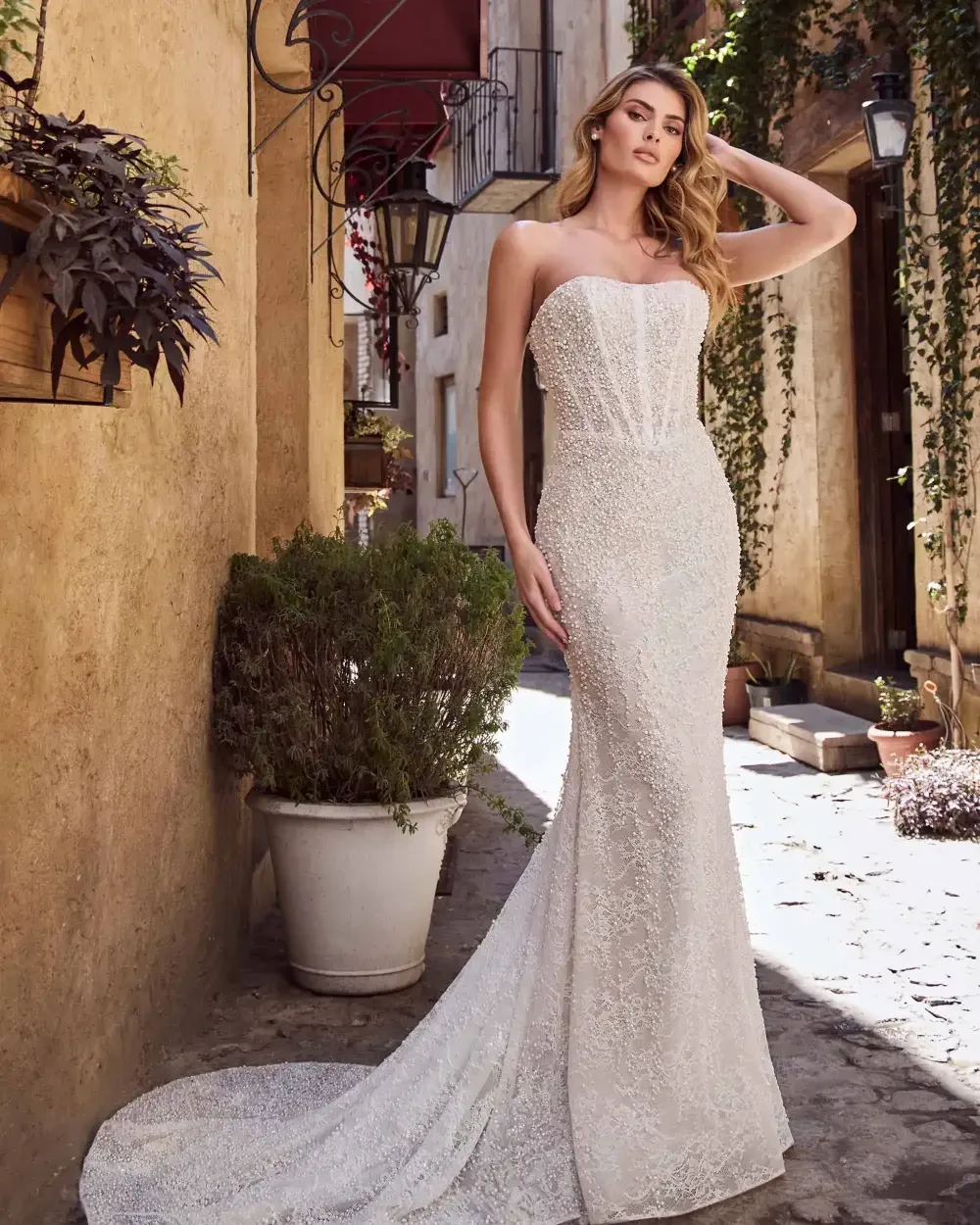 model is wearing a strapless beaded bridal gown