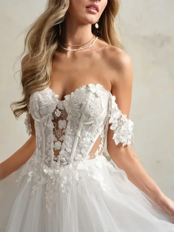 model is wearing an off the shoulder a-line wedding dress