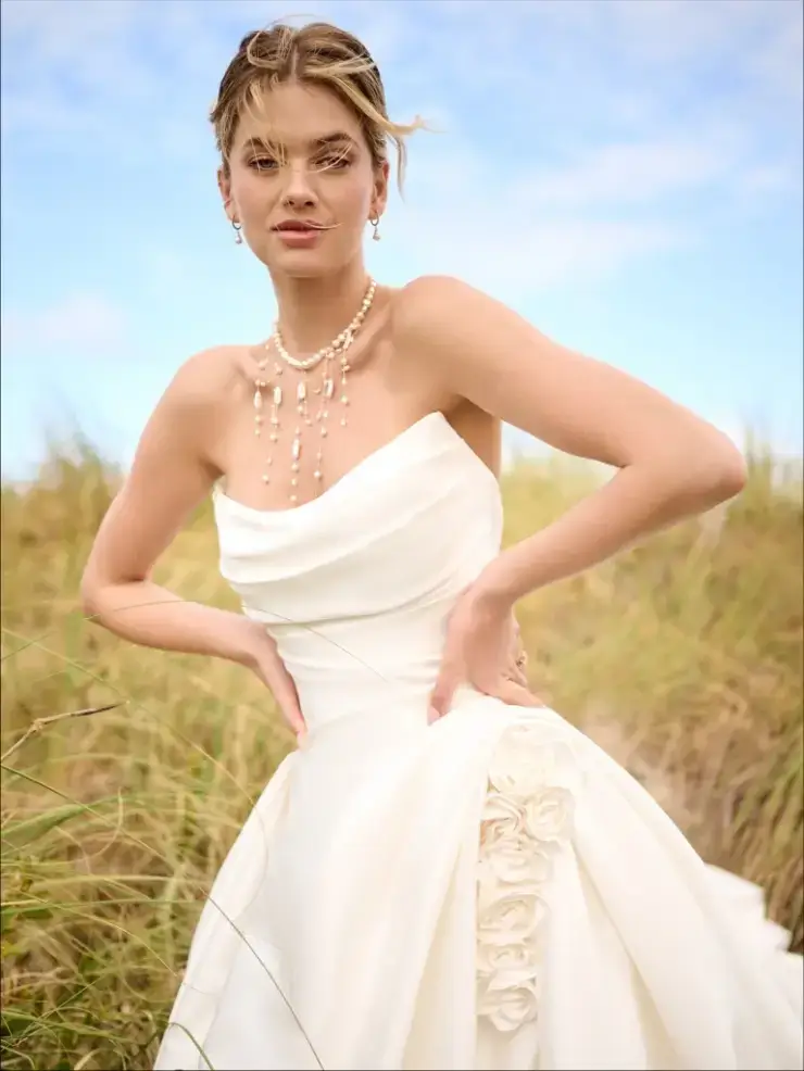 model is wearing a strapless ball gown