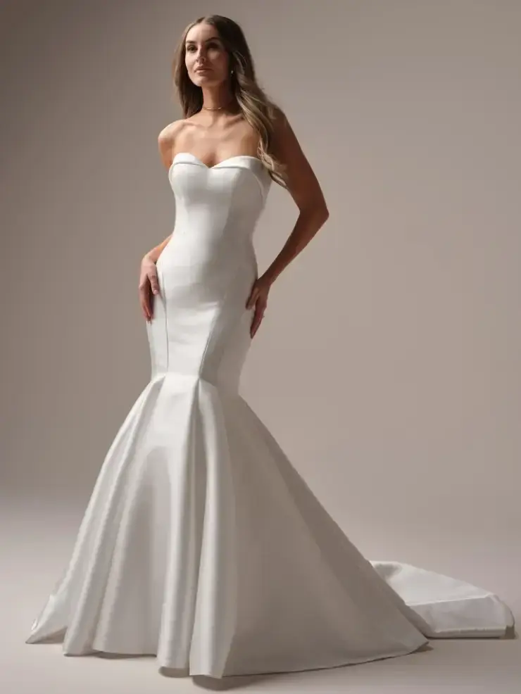 model is wearing a strapless fit and flare wedding gown