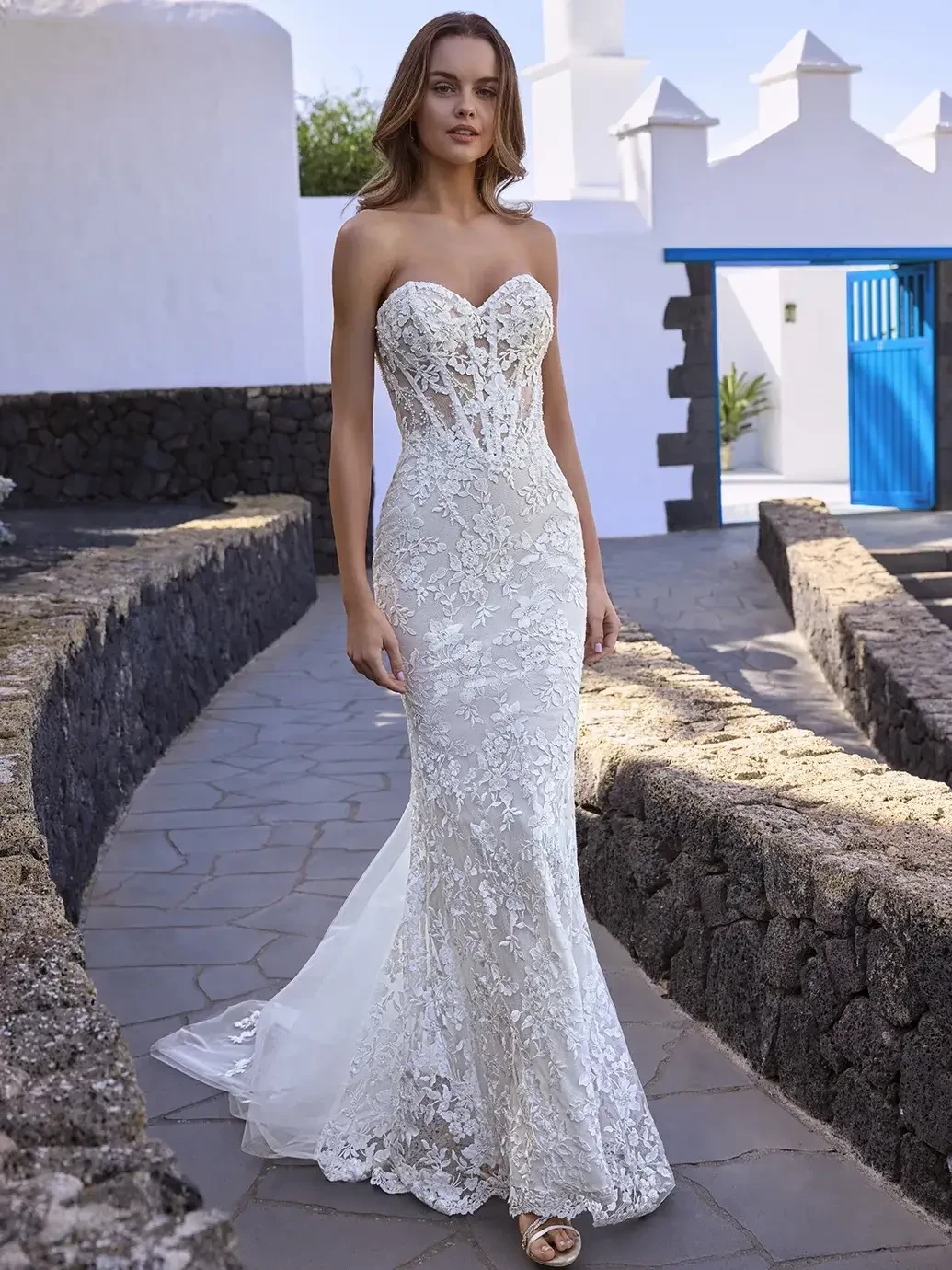 model is wearing a strapless lace sweetheart neckline wedding dress