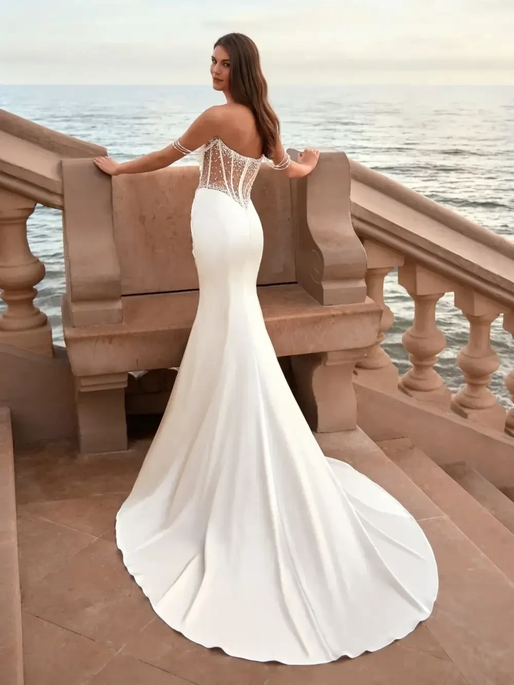 model is wearing a strapless fit and flare wedding dress