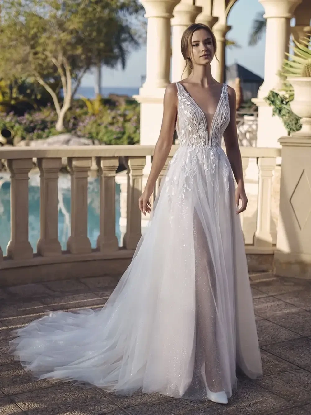 model is wearing a sleeveless bridal gown
