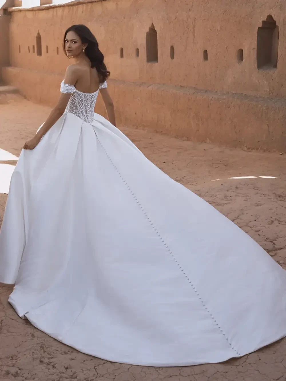 model is wearing an off the shouder bridal gown