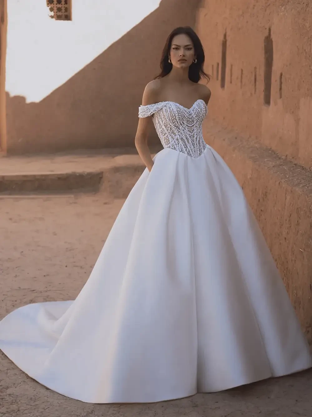 model is wearing an off the shouder bridal gown