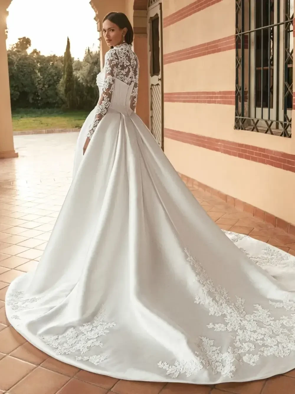 model is wearing a long sleeve high neck lace wedding dress