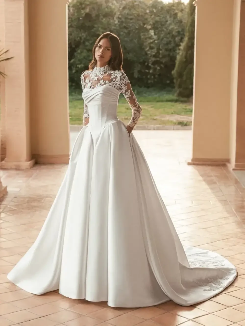 model is wearing a long sleeve high neck lace wedding dress